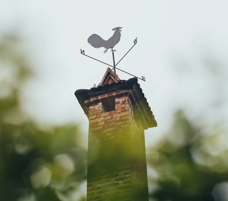 brick chimney with rooster weather vane