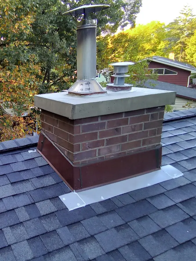 brick chimney on roof of home