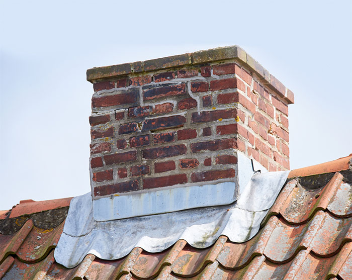 Brick chimney with brick damage