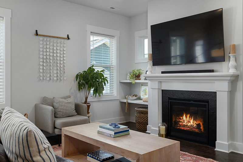 Living room with a lit fireplace