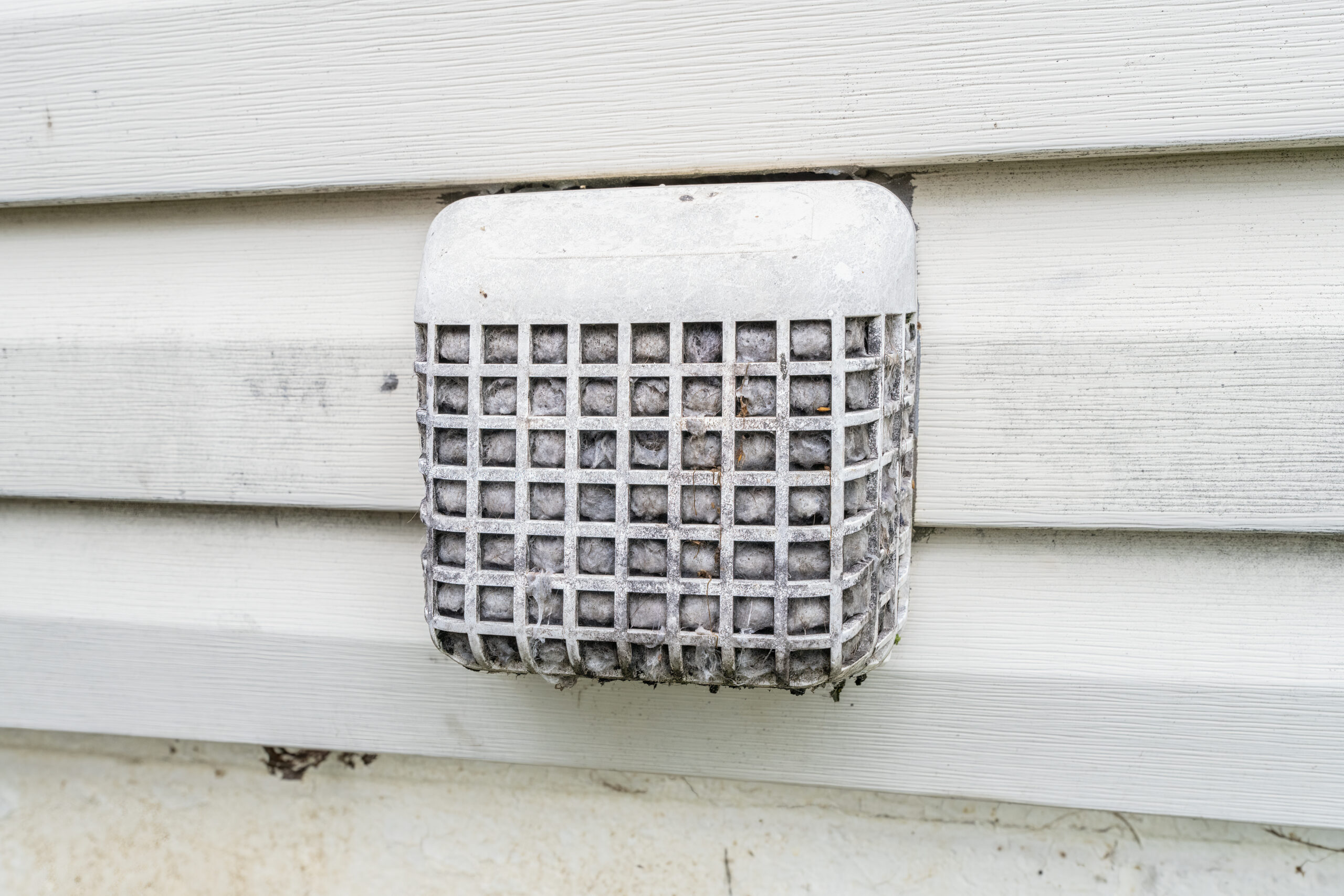 Adobe Stock image of a clogged up dryer exhaust return vent.