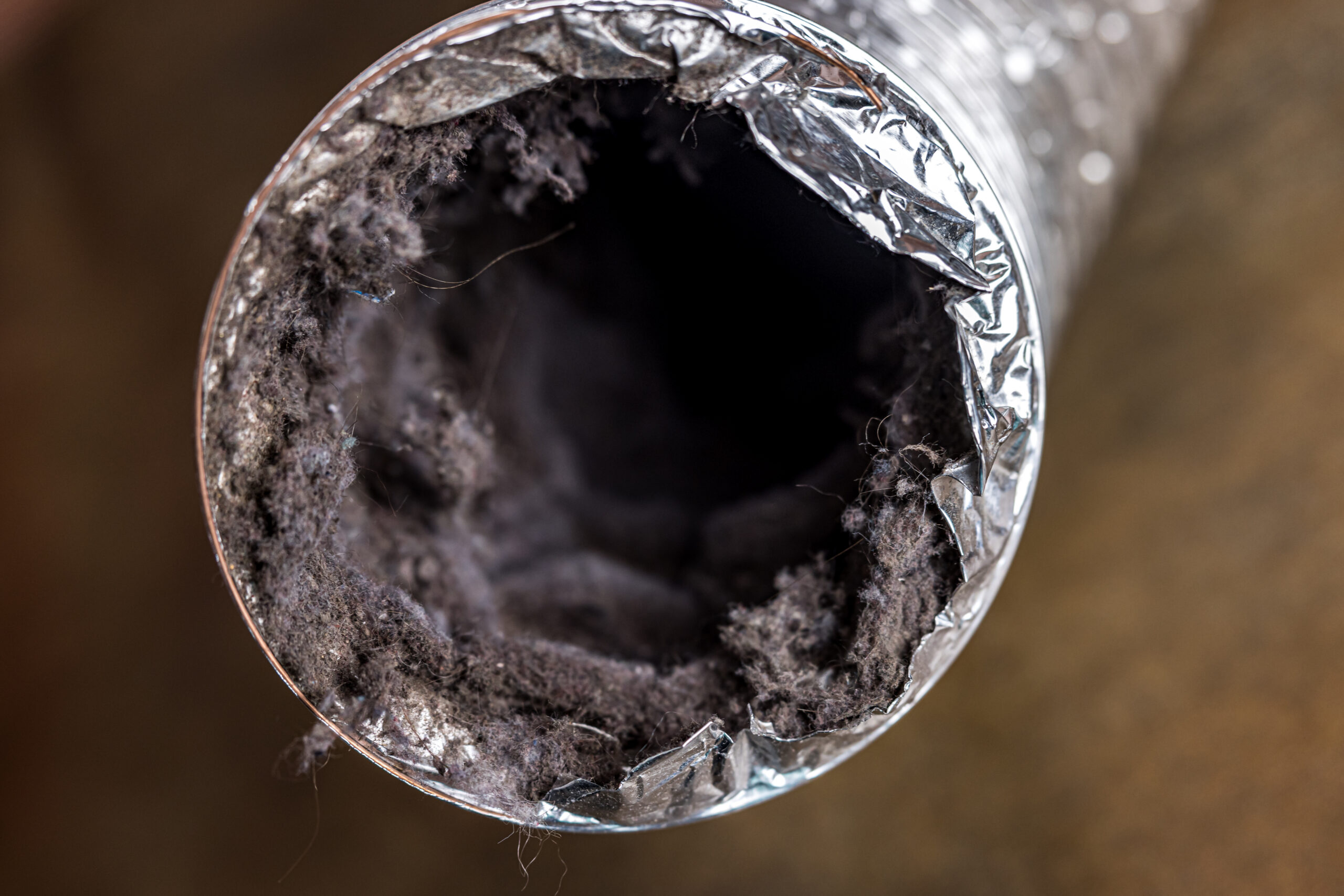 Adobe Stock image of a dirty lint-filled dryer vent.