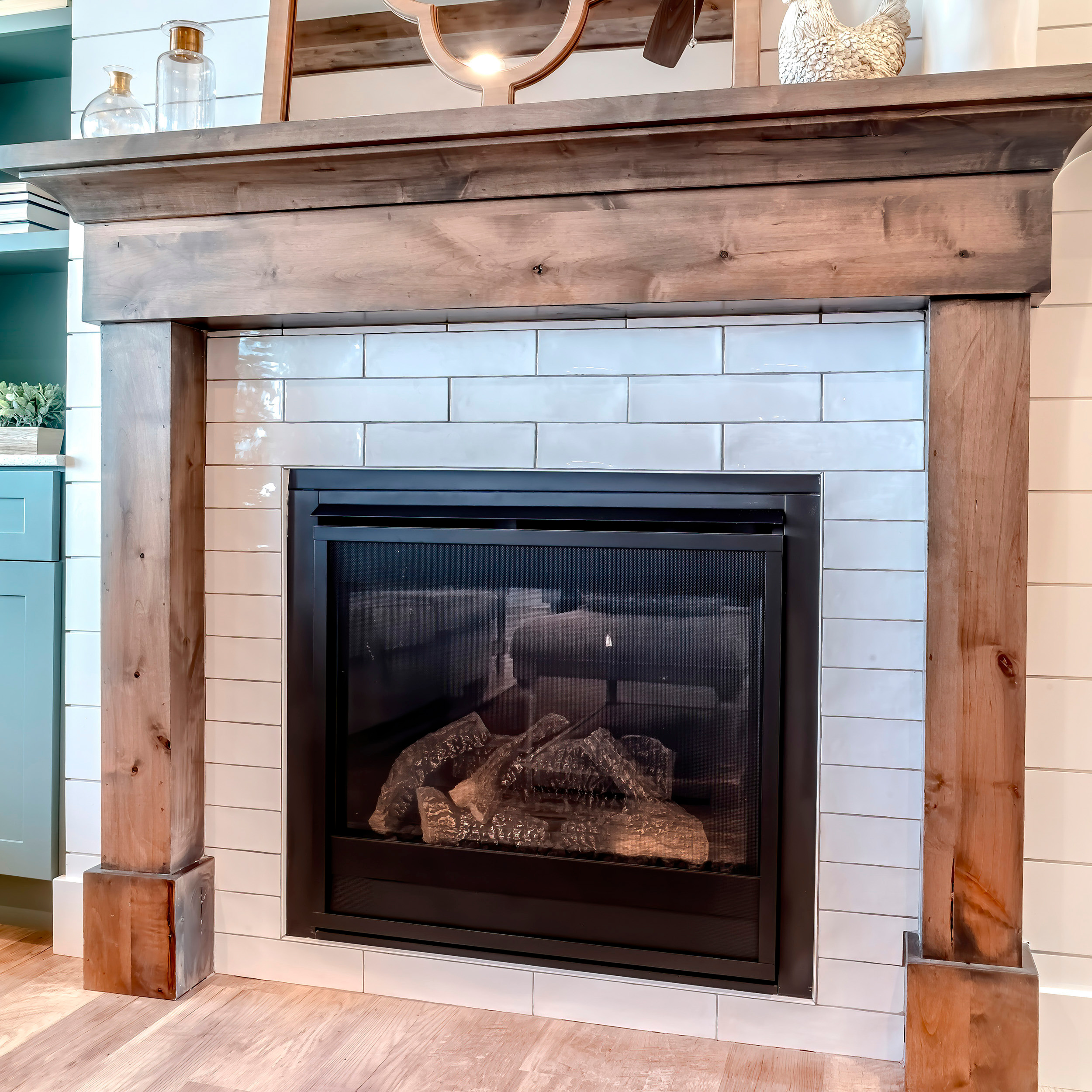 Adobe Stock image of a fireplace with brick and wood surround.