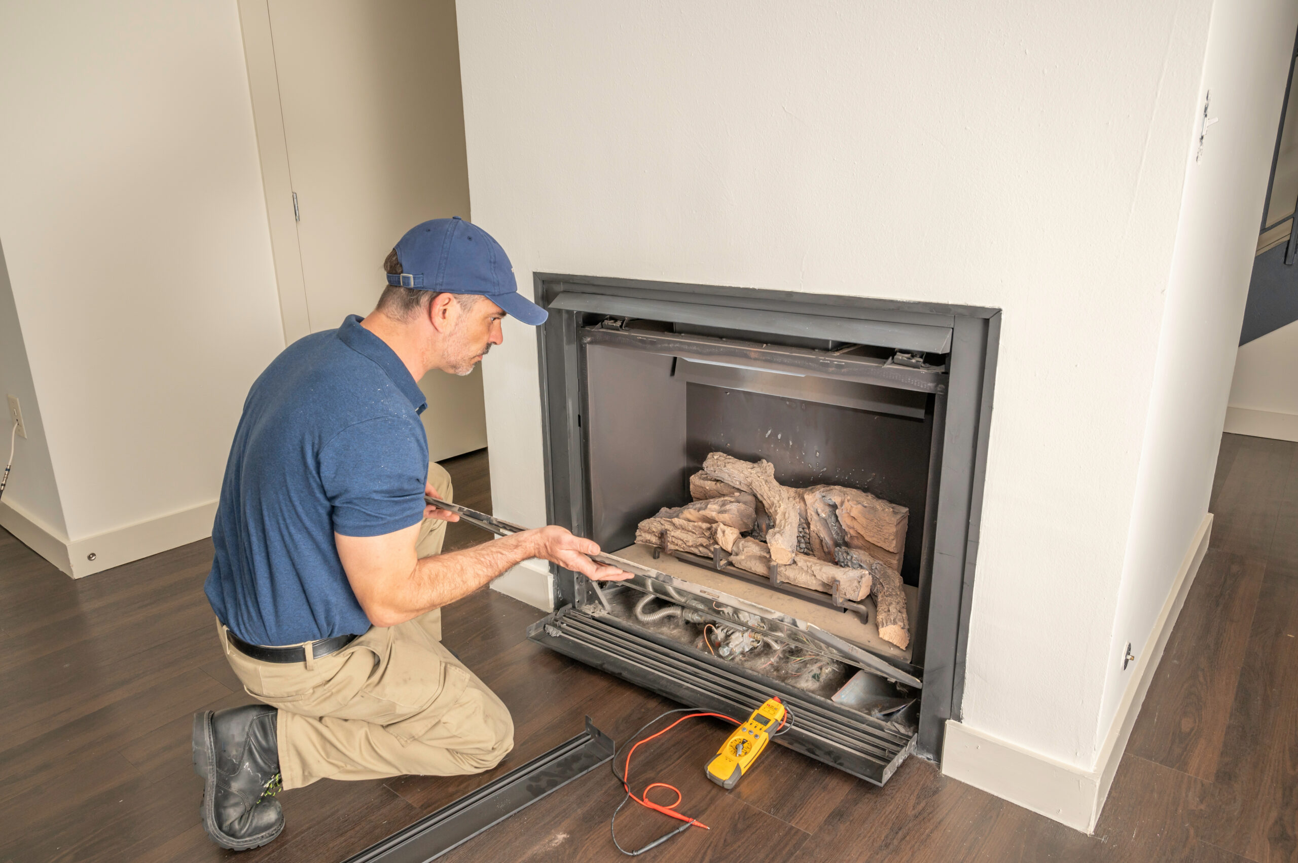 Adobe stock image of a man installing a fireplace.