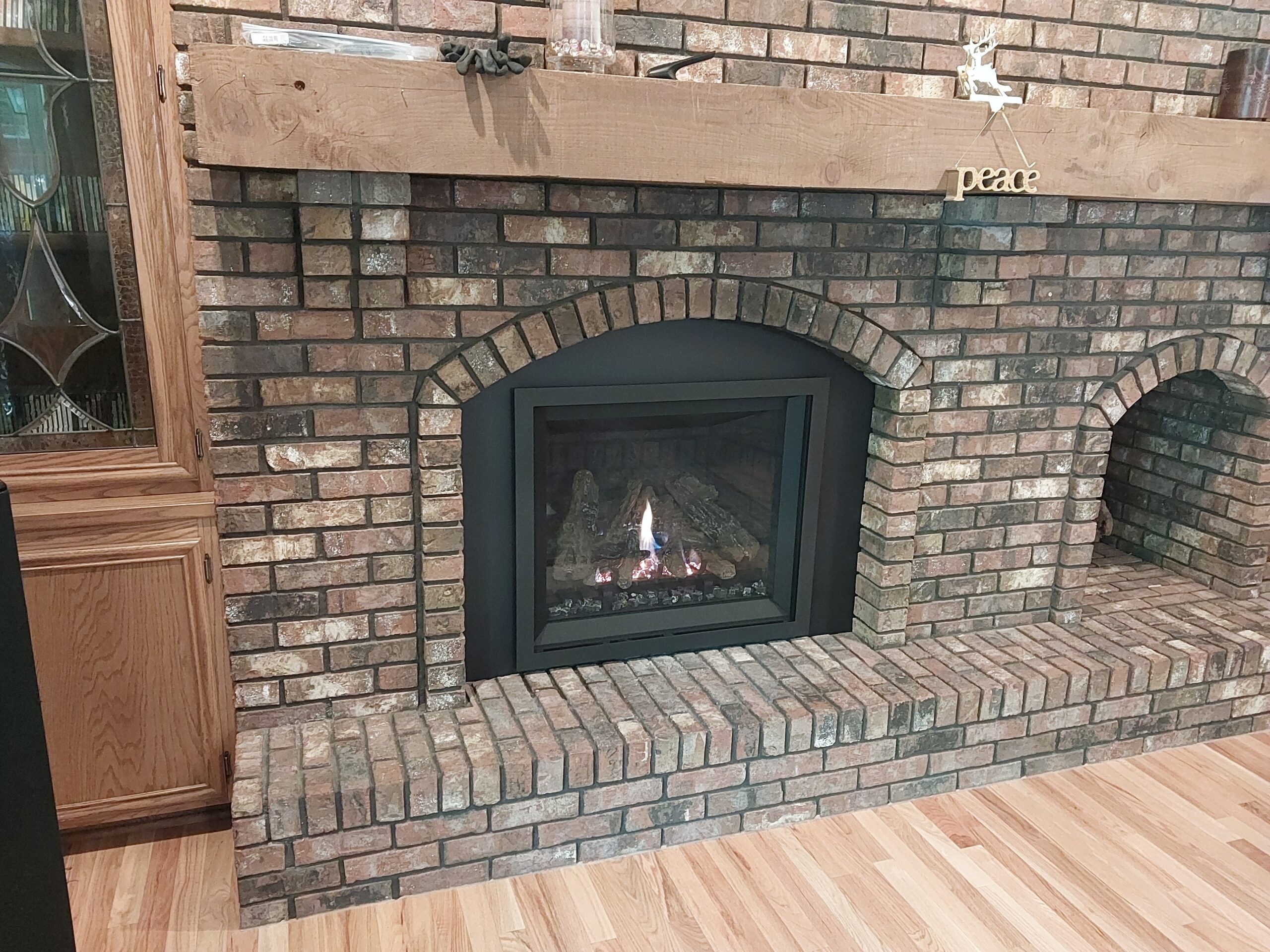 A gas fireplace insert upgrade on a masonry fireplace.